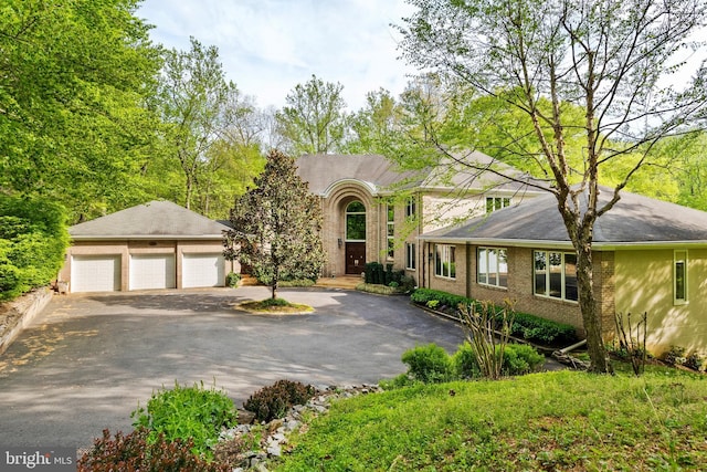 view of front of house featuring a garage and brick siding