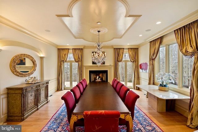 dining area with plenty of natural light, light wood finished floors, and a chandelier