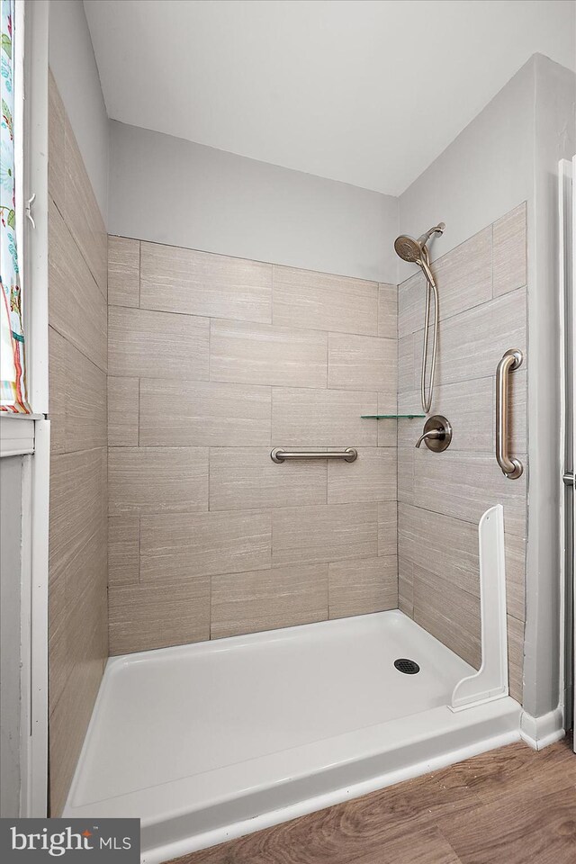 full bathroom with a tile shower
