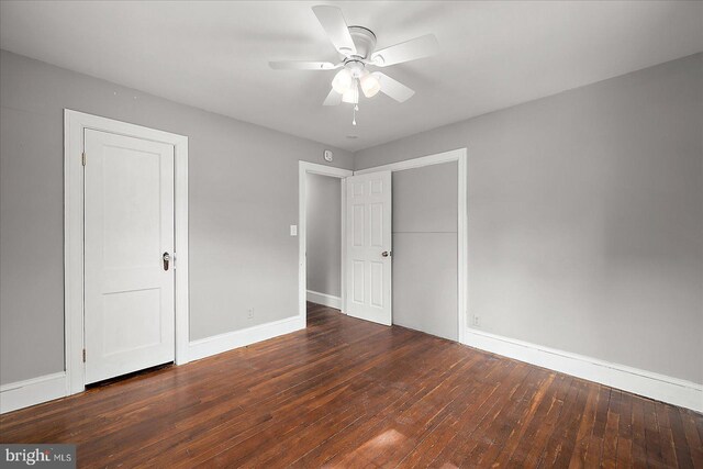 unfurnished bedroom with ceiling fan, hardwood / wood-style flooring, and baseboards