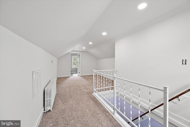 additional living space featuring lofted ceiling, carpet flooring, visible vents, baseboards, and recessed lighting