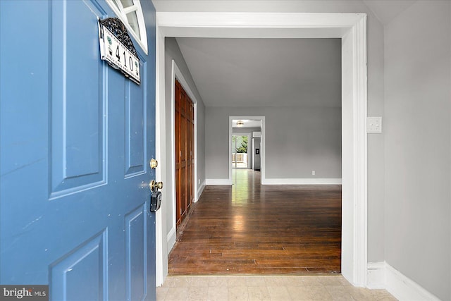 entryway with hardwood / wood-style flooring and baseboards