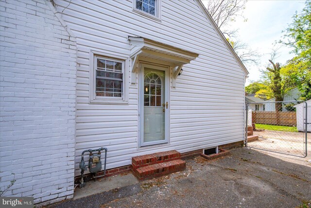entrance to property featuring fence