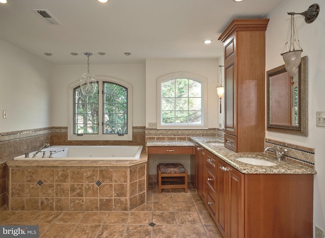 full bathroom featuring visible vents, vanity, recessed lighting, and a bath
