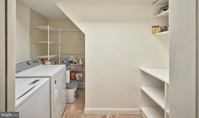 clothes washing area with washer and clothes dryer and laundry area
