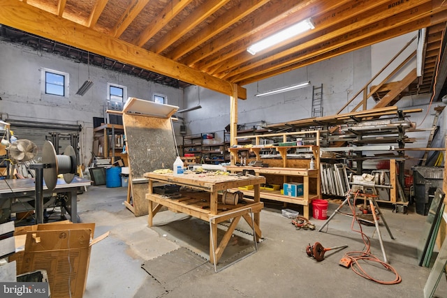 miscellaneous room with a workshop area and concrete flooring