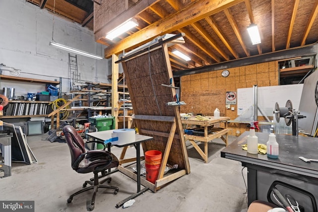 miscellaneous room featuring a workshop area and concrete flooring
