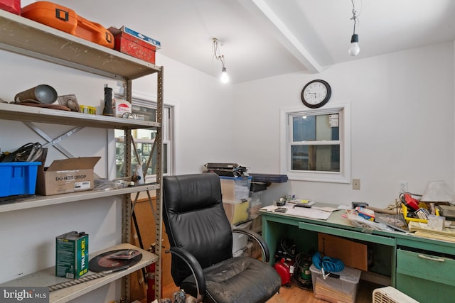 home office with beam ceiling and wood finished floors