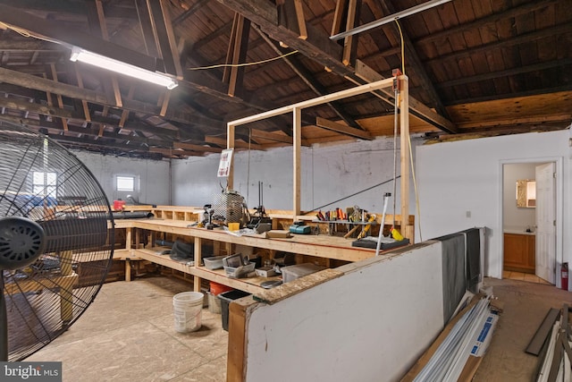 misc room with lofted ceiling and a workshop area