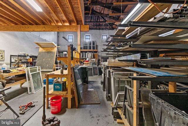 miscellaneous room with a workshop area and concrete floors