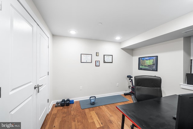 office space featuring recessed lighting, wood finished floors, visible vents, and baseboards
