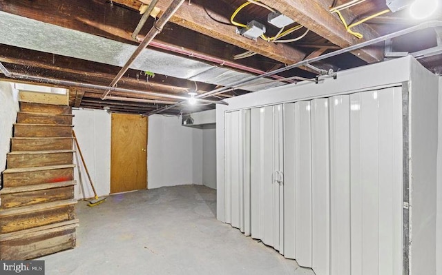 unfinished basement featuring stairway