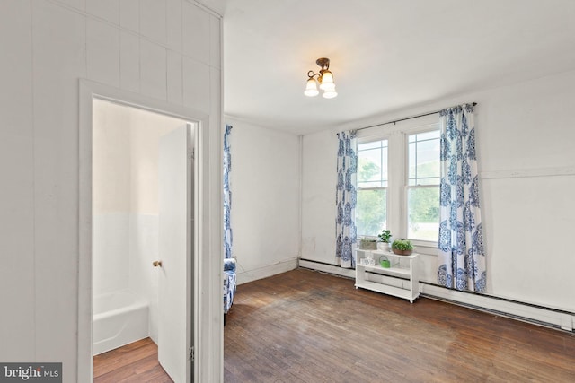 911 Martinsburg Pike, Winchester, VA 22601 - spare room featuring wood finished floors and a baseboard heating unit