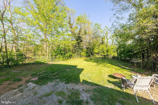 view of yard featuring fence and a fire pit