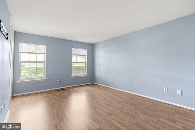 unfurnished room featuring wood finished floors and baseboards