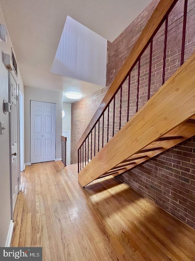 2904 11th St NW, Washington, DC 20001 - entrance foyer featuring stairway, wood finished floors, baseboards, and brick wall