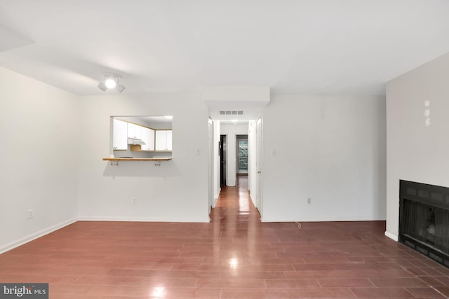 2904 11th St NW, Washington, DC 20001 - unfurnished living room featuring wood finished floors, a fireplace, visible vents, and baseboards
