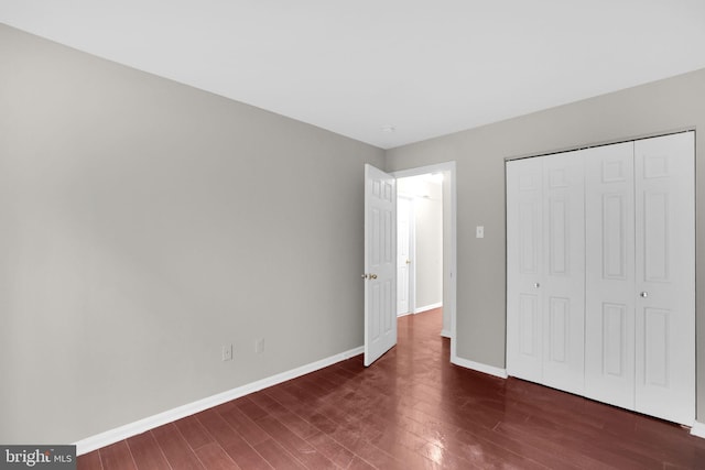 2904 11th St NW, Washington, DC 20001 - unfurnished bedroom featuring a closet, dark wood-type flooring, and baseboards