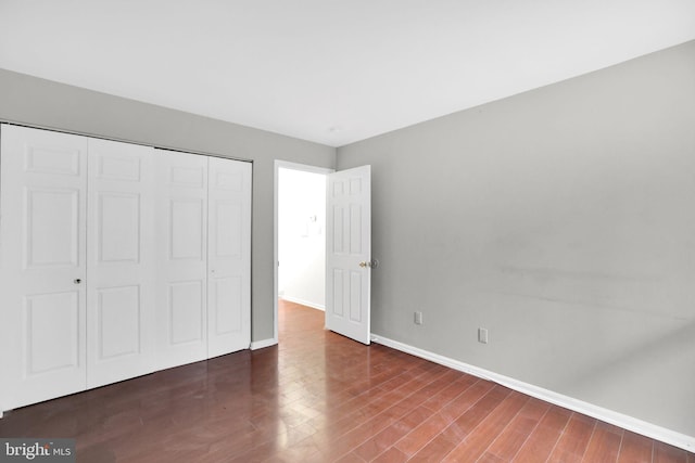 2904 11th St NW, Washington, DC 20001 - unfurnished bedroom featuring a closet, baseboards, and wood finished floors