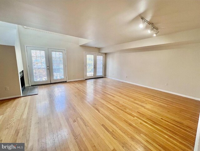 2904 11th St NW, Washington, DC 20001 - unfurnished room with track lighting, french doors, baseboards, and light wood-style floors