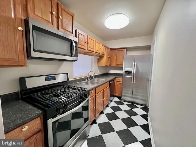 2904 11th St NW, Washington, DC 20001 - kitchen with a sink, stainless steel appliances, dark countertops, and dark floors