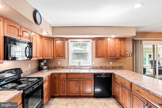 3672 Cimmeron Rd, York, PA 17402 - kitchen featuring brown cabinetry, black appliances, plenty of natural light, and a sink