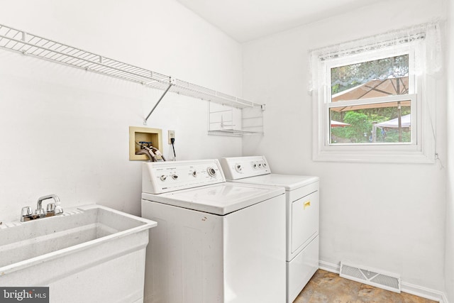 3672 Cimmeron Rd, York, PA 17402 - laundry room with baseboards, washer and dryer, visible vents, a sink, and laundry area
