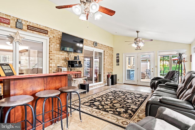 3672 Cimmeron Rd, York, PA 17402 - tiled living area featuring lofted ceiling, french doors, a ceiling fan, brick wall, and a bar
