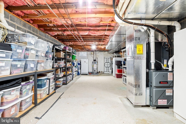 3672 Cimmeron Rd, York, PA 17402 - unfinished below grade area featuring heating unit, freestanding refrigerator, and gas water heater