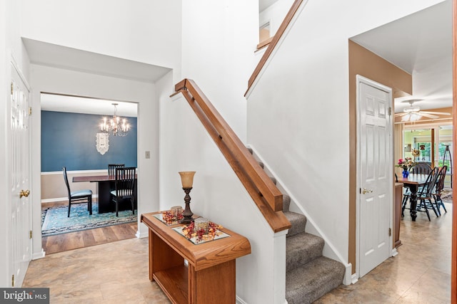 3672 Cimmeron Rd, York, PA 17402 - staircase with a towering ceiling, baseboards, and ceiling fan with notable chandelier