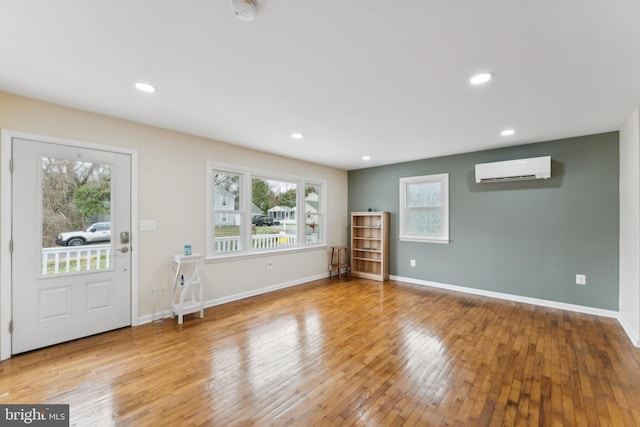 entrance foyer with hardwood / wood-style floors, recessed lighting, baseboards, and a wall mounted AC