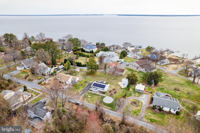 drone / aerial view featuring a residential view and a water view
