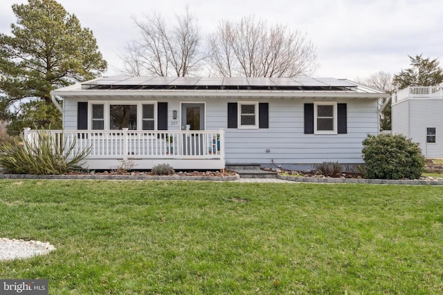 single story home with solar panels and a front yard