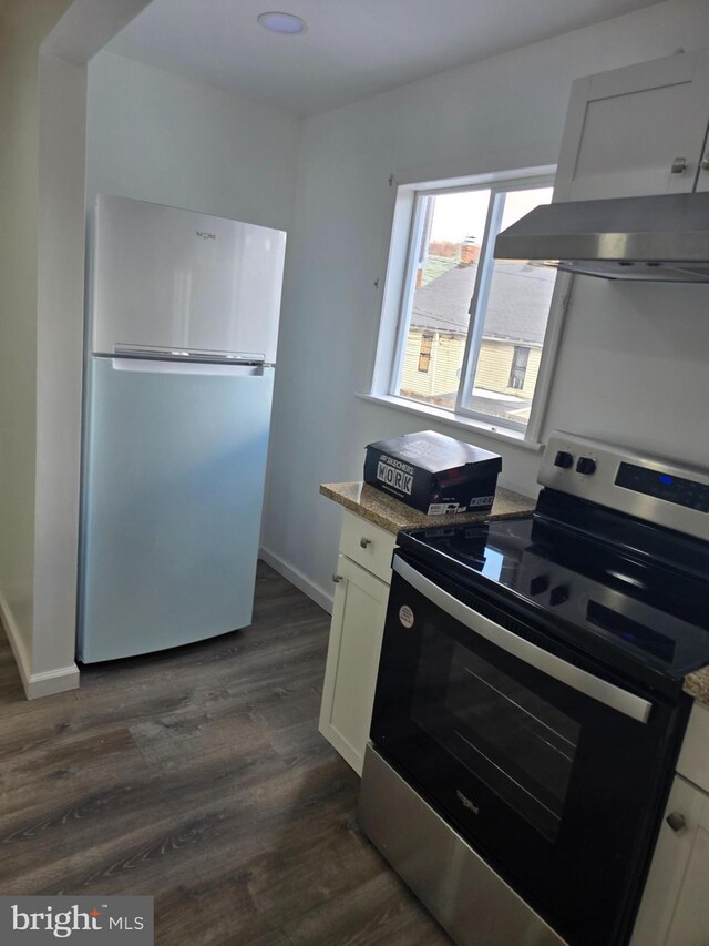 325 W Washington St, Tamaqua, PA 18252 - kitchen with range hood, baseboards, dark wood-type flooring, white cabinets, and appliances with stainless steel finishes