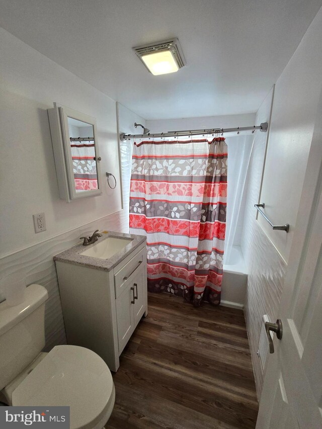 325 W Washington St, Tamaqua, PA 18252 - full bath featuring toilet, wainscoting, wood finished floors, shower / bath combination with curtain, and vanity