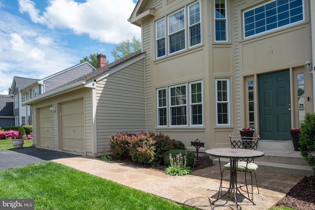 11 Ashbrook Rd, Stafford, VA 22554 - view of property exterior with a chimney, asphalt driveway, and a garage