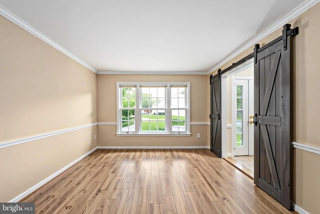 11 Ashbrook Rd, Stafford, VA 22554 - entryway featuring a barn door, baseboards, light wood-type flooring, and crown molding