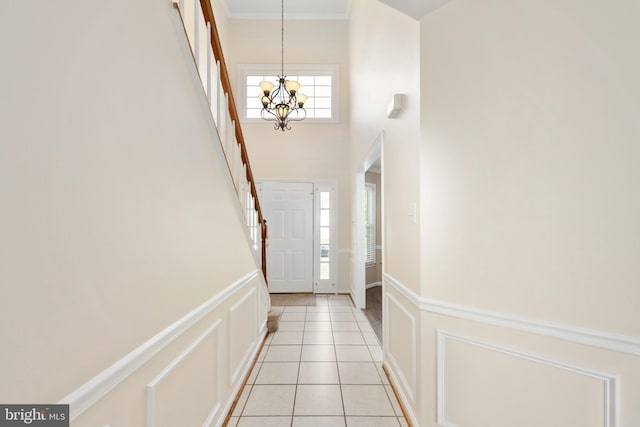 11 Ashbrook Rd, Stafford, VA 22554 - doorway to outside with a chandelier, light tile patterned flooring, a towering ceiling, and ornamental molding