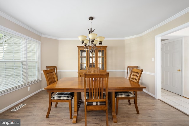 11 Ashbrook Rd, Stafford, VA 22554 - dining area with a chandelier, ornamental molding, baseboards, and light wood-style flooring