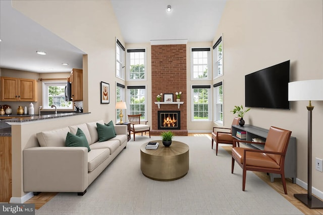 11 Ashbrook Rd, Stafford, VA 22554 - living area with a towering ceiling, a brick fireplace, baseboards, light wood finished floors, and recessed lighting