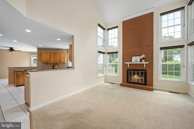 11 Ashbrook Rd, Stafford, VA 22554 - unfurnished living room with a towering ceiling, baseboards, a brick fireplace, ceiling fan, and recessed lighting