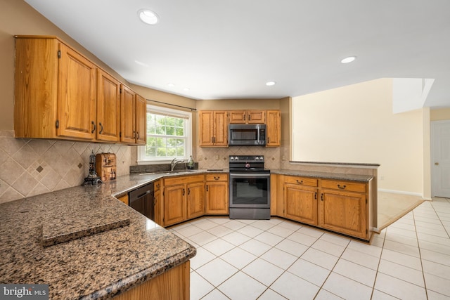 11 Ashbrook Rd, Stafford, VA 22554 - kitchen with appliances with stainless steel finishes, a peninsula, light tile patterned floors, backsplash, and brown cabinets