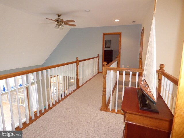 hallway with carpet, vaulted ceiling, an upstairs landing, and recessed lighting