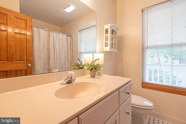 bathroom with toilet, tile patterned floors, vanity, and a shower with shower curtain