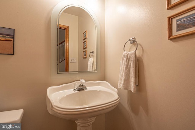 bathroom featuring toilet and a sink