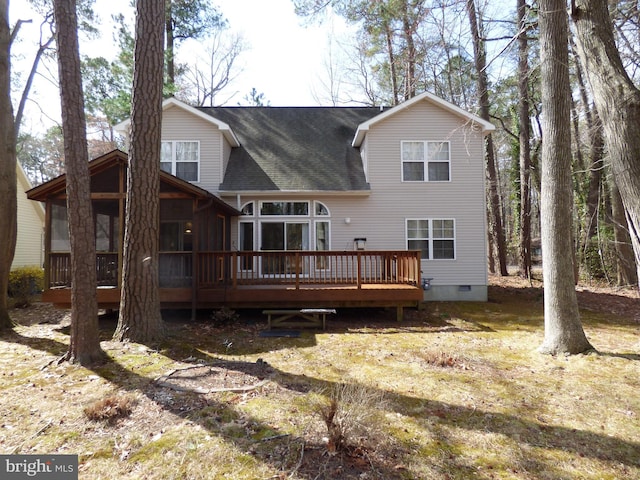 back of house featuring a sunroom, a shingled roof, crawl space, and a deck