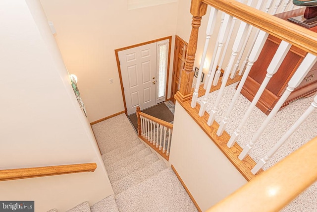 stairway with carpet flooring and baseboards