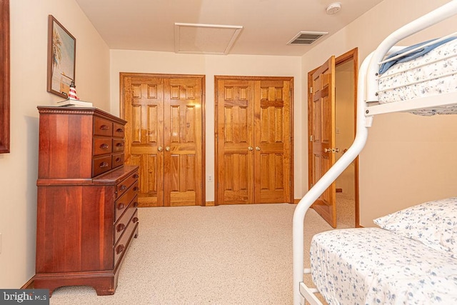 carpeted bedroom with attic access and visible vents
