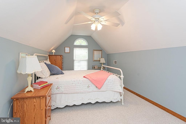 carpeted bedroom featuring vaulted ceiling, baseboards, and ceiling fan