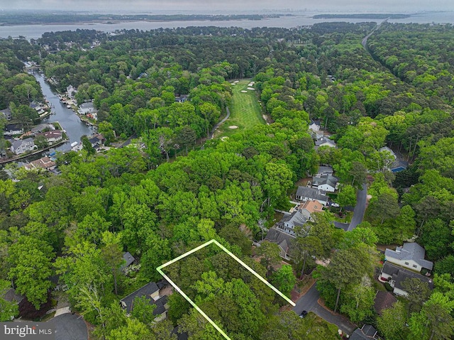 aerial view with a water view, a forest view, and a residential view